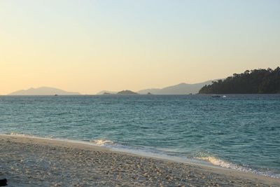 Scenic view of sea against clear sky during sunset