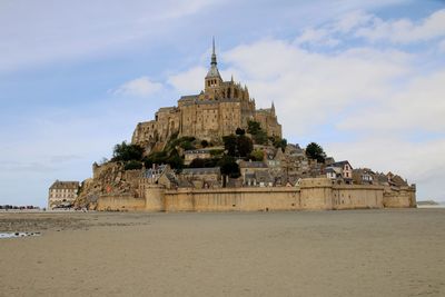 View of saint michel in france by sea against sky