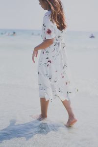 Full length of woman standing on beach