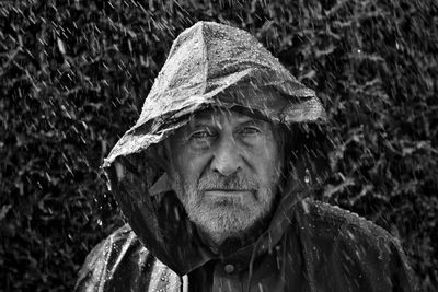 Portrait of man wearing raincoat during rainfall