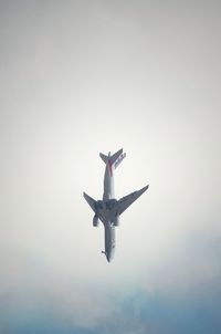 Low angle view of airplane flying in sky