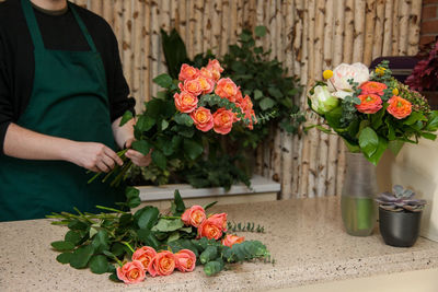 Florist arranging a bouquet of roses