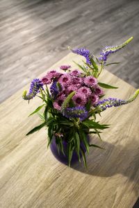 High angle view of purple flower vase on table