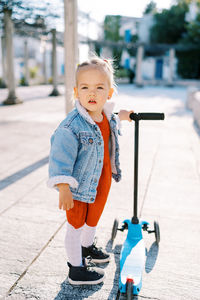 Portrait of boy standing on road