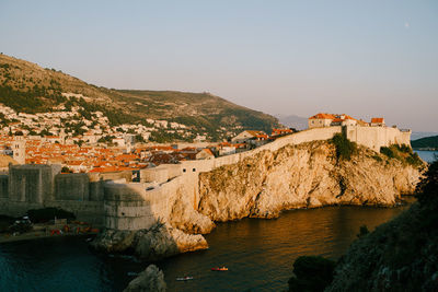 Town by sea against clear sky