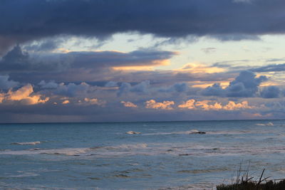 Scenic view of sea against cloudy sky