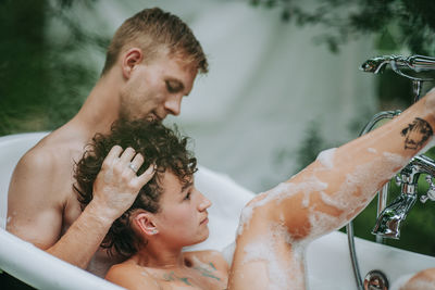 Portrait of father and son in bathroom