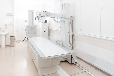 X-ray department in modern hospital. radiology room with scan machine with empty bed.