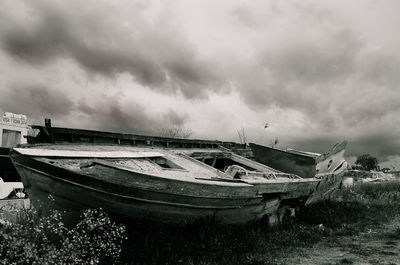 Boat in sea against cloudy sky