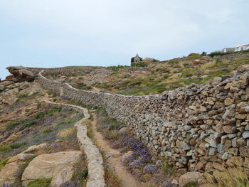 View of stone wall against sky, greece