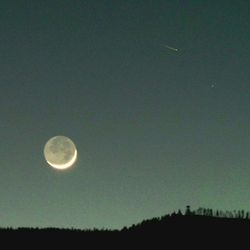 Low angle view of moon against sky at night