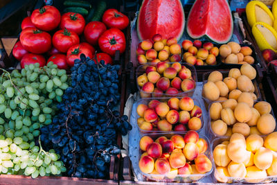 Fresh ripe fruits on the market in boxes