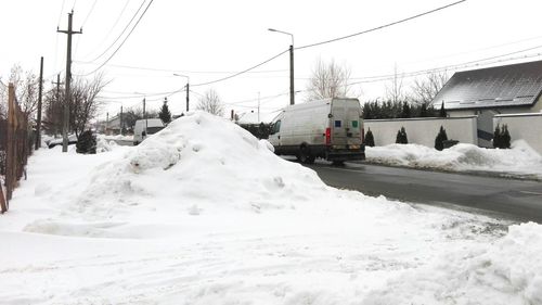 Snow covered cars on road during winter