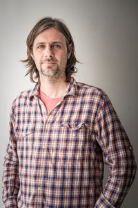 Portrait of mid adult man against gray background