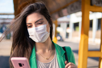 Portrait of young woman using mobile phone