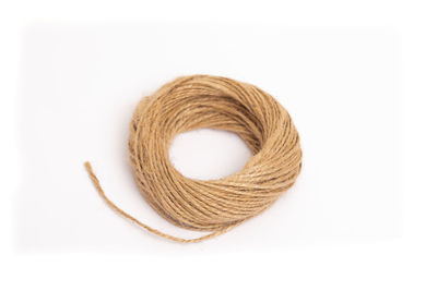 Close-up of rope over white background