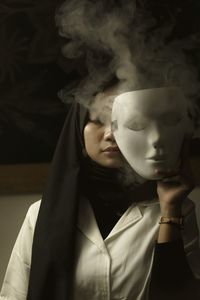 Portrait of asian woman behind the white mask