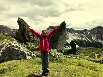 Woman standing on mountain against sky