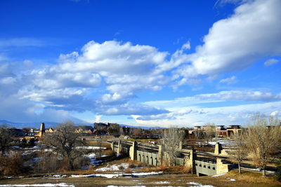 Buildings in city against blue sky