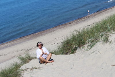 Portrait of man sitting on beach