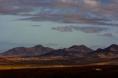 Scenic view of mountains against cloudy sky