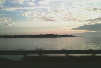 Scenic view of lake against sky at sunset