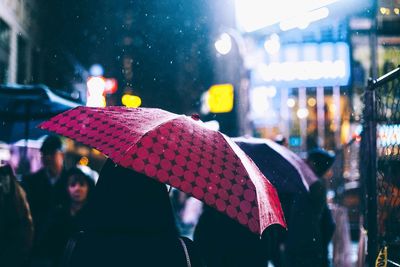 Close-up of wet illuminated street during rainy season