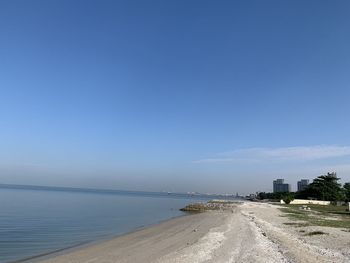 Scenic view of beach against blue sky