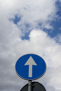 Low angle view of road sign against sky