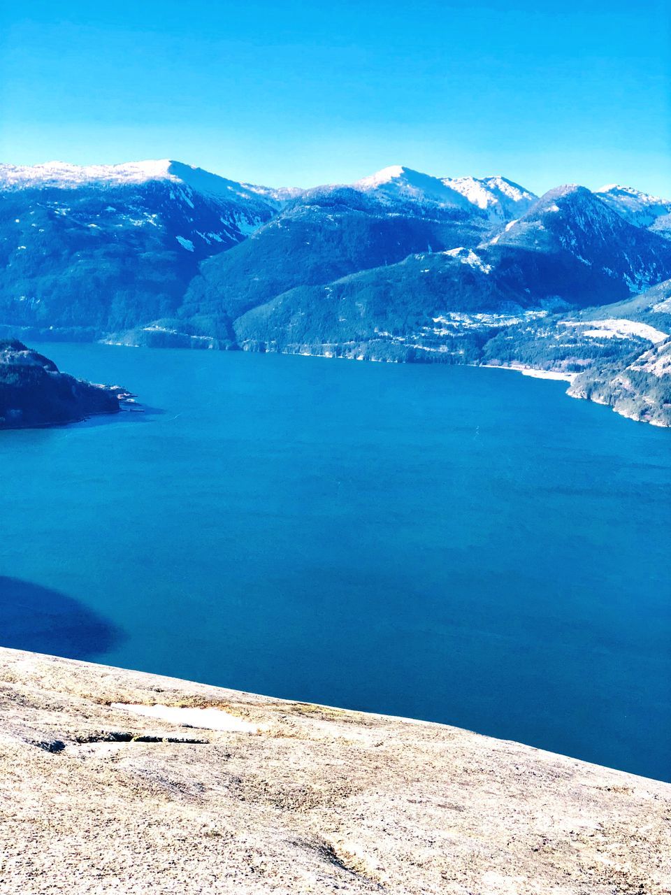 water, scenics - nature, beauty in nature, blue, tranquility, tranquil scene, mountain, sky, sea, day, nature, cold temperature, no people, mountain range, idyllic, winter, outdoors, snow, land, snowcapped mountain, turquoise colored