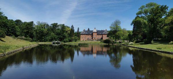 Reflection of trees and buildings in lake