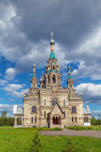 Low angle view of church against cloudy sky