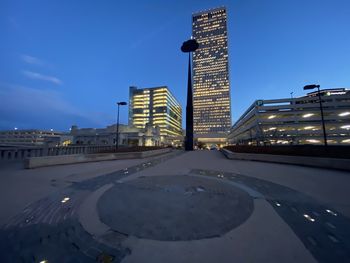 View of city buildings against blue sky