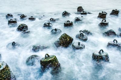 High angle view of rocks in sea