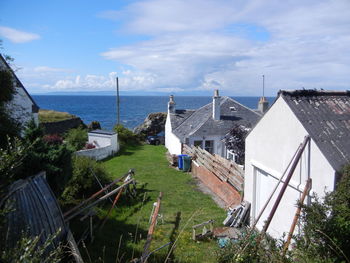 High angle view of buildings by sea against sky