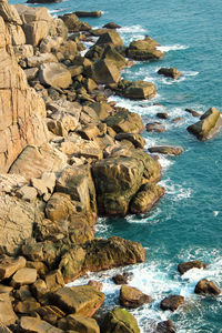 Scenic view of rock formations by sea