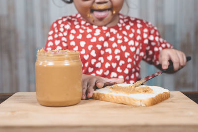 Close-up of woman holding drink on table