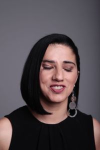 Portrait of a smiling young woman against gray background