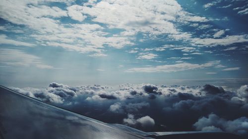 Airplane wing against sky