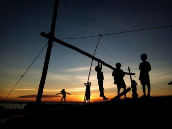 Silhouette of people at sunset