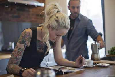 Young couple looking through a magazine