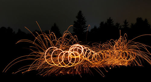 Low angle view of firework display at night