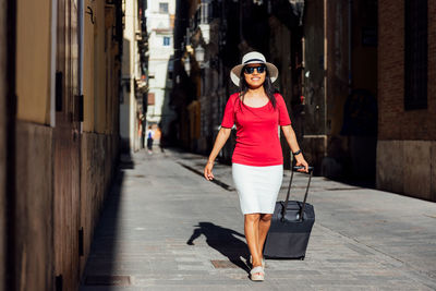 Full length portrait of woman walking in city