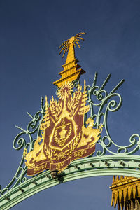 Low angle view of statue against building against sky