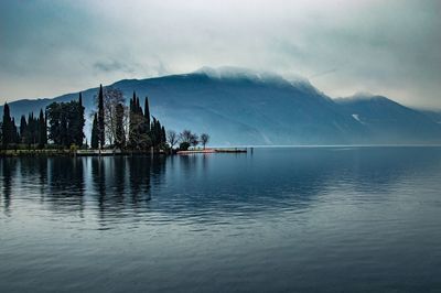 Scenic view of lake by mountains against sky