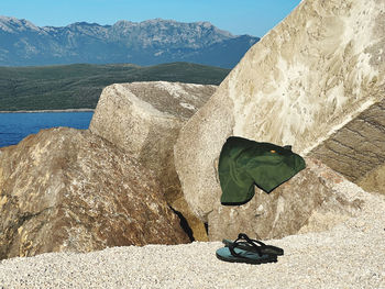 Low section of woman standing on beach against sky