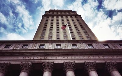 Low angle view of building against cloudy sky