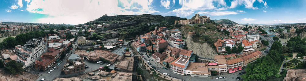 Panoramic view of buildings in town against sky