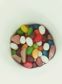 High angle view of multi colored candies on white background