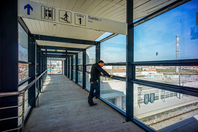 Side view of man standing on railroad station platform